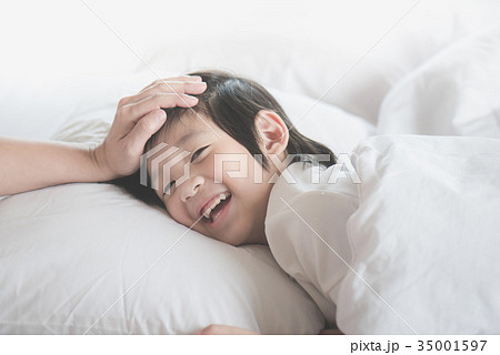Asian child sleeping on white bed Asian child sleeping on white bed 35001597