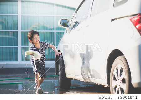 asian child washing a car on summer day 35001941