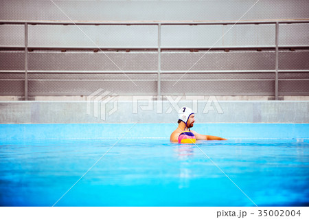 Water polo player in a swimming pool. Water polo player in a swimming pool. 35002004