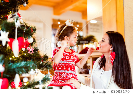 Young mother with daughter at Christmas tree at Young mother with daughter at Christmas tree at 35002170