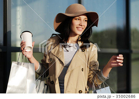 A young girl walks from a shopping center with 35002686