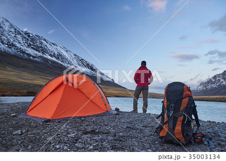 Hiker stand at camping in the mountains during Hiker stand at camping in the mountains during 35003134