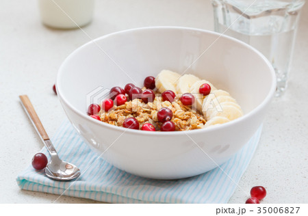 Muesli with banana and berries for breakfast. 35006827