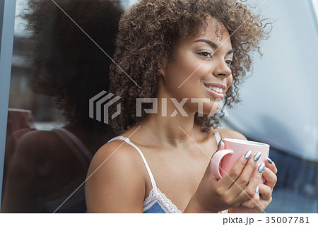 Outgoing girl drinking cup of beverage 35007781