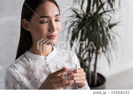 Smiling lady relaxing at work Smiling lady relaxing at work 35008202