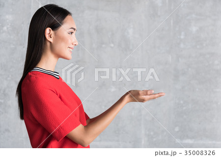 Happy smiling female person near wall 35008326