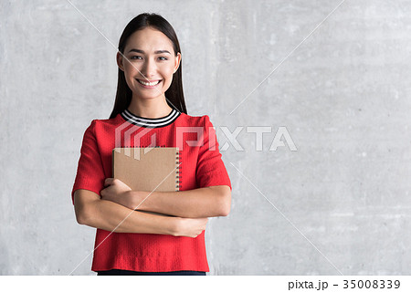 Hilarious smiling lady holding diary Hilarious smiling lady holding diary 35008339