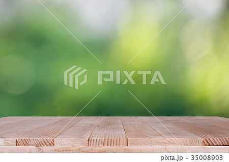 Wood table top on bokeh green background Wood table top on bokeh green background 35008903
