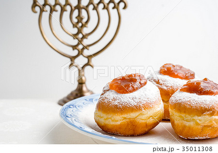 Hanukkah Minor, donuts with jam on a plate on a Hanukkah Minor, donuts with jam on a plate on a 35011308