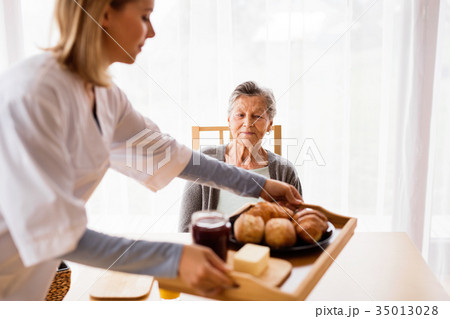 Health visitor and a senior woman during home Health visitor and a senior woman during home 35013028
