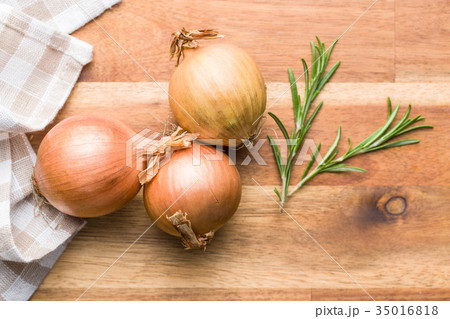Fresh onion bulbs and rosemary branch. 35016818