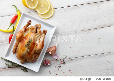 Roasted chicken with herbs and spices for holiday dinner Roasted chicken with herbs and spices for holiday dinner 35018306