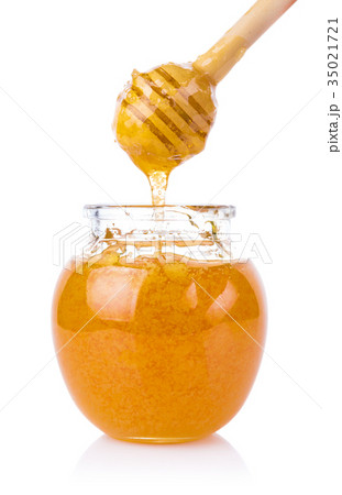 glass jar of honey and stick isolated on white glass jar of honey and stick isolated on white 35021721