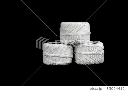 roll of white rope on black background roll of white rope on black background 35024412