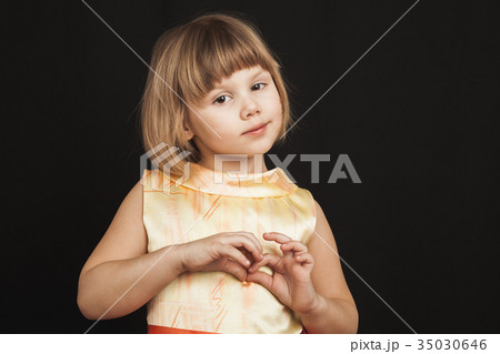 Caucasian blond girl in yellow dress on black Caucasian blond girl in yellow dress on black 35030646