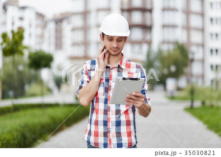 Young architect in front of apartment building 35030821