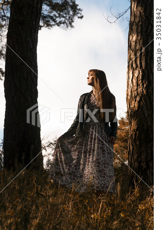 young beautiful woman posing near big tree young beautiful woman posing near big tree 35031842