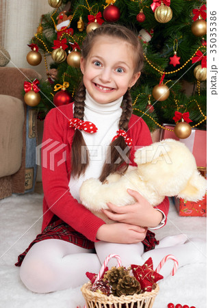 Unhappy girl crying near christmas tree 35035386