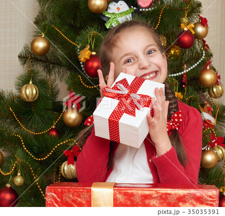 Unhappy girl crying near christmas tree 35035391