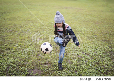 サッカーボールで遊ぶ女の子の写真素材