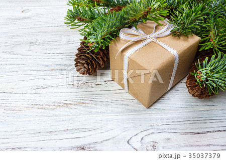 Christmas gift box on the white wooden background 35037379