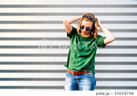 Young woman standing against the wall. Young woman standing against the wall. 35038748