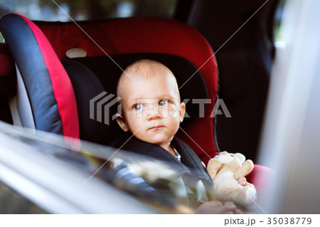 Little baby boy sitting in the car seat in the car 35038779