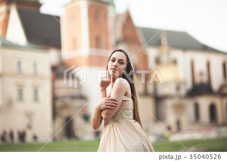 Girl in luxurious long dress on street of old town Girl in luxurious long dress on street of old town 35040526