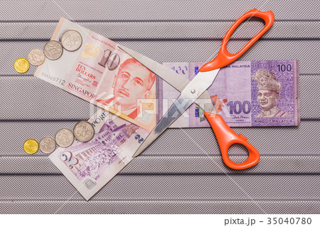 Singapore dollar and Coins on top of Ringgit 35040780