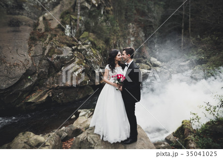 Wedding couple, groom and bride hugging, outdoor Wedding couple, groom and bride hugging, outdoor 35041025