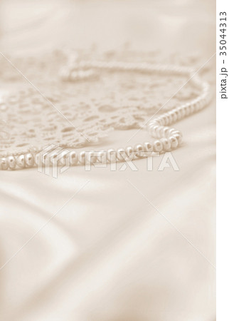 Smooth elegant golden silk or satin with pearls Smooth elegant golden silk or satin with pearls 35044313