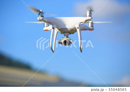Flying drone with camera on the sky Flying drone with camera on the sky 35048565