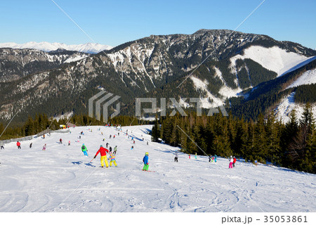 The skiers and snowborders are on slope in Jasna 35053861