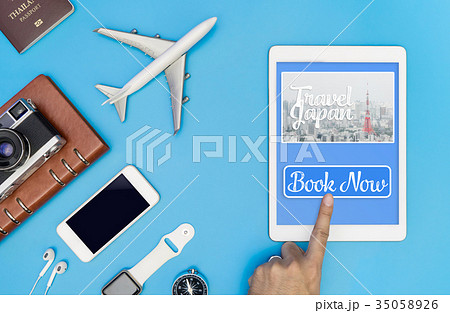 touching Empty tablet screen to book trip to Japan 35058926