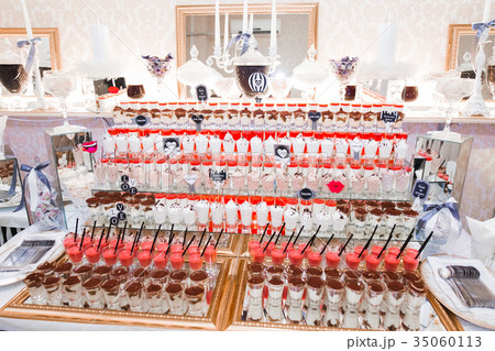 Delicious and tasty dessert table with cupcakes 35060113