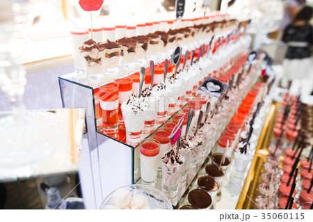 Delicious sweets on wedding candy buffet with 35060115