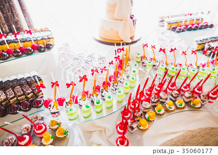 Delicious sweets on wedding candy buffet with 35060177