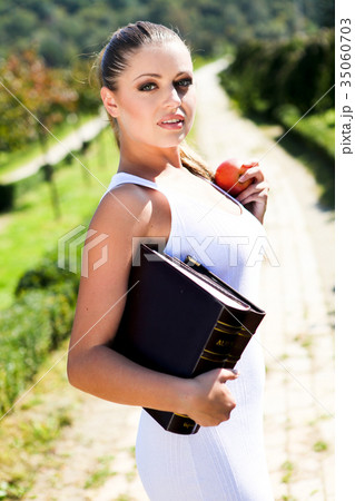 Beauty woman with book and red apple Beauty woman with book and red apple 35060703