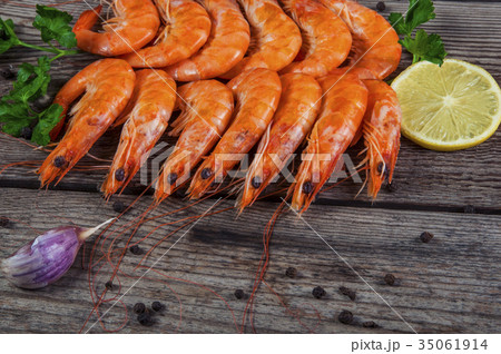 Selection of shrimps for dinner on wooden plate Selection of shrimps for dinner on wooden plate 35061914