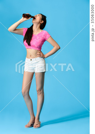 full length of woman standing in blue background full length of woman standing in blue background 35063000
