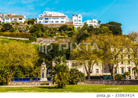 houses on a cliff hill, on rock among green plants 35063414