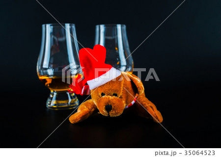 Plush teddy bear with single malt whisky in glass Plush teddy bear with single malt whisky in glass 35064523