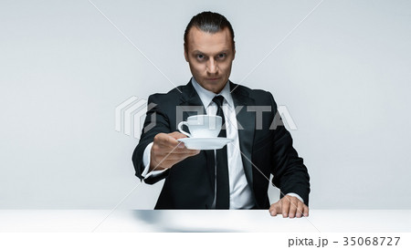 The attractive man in black suit on white The attractive man in black suit on white 35068727