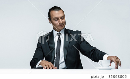 The attractive man in black suit on white The attractive man in black suit on white 35068806