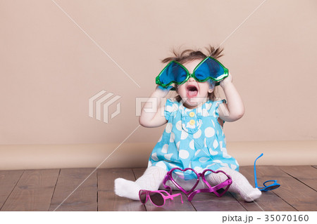 little girl plays with big glasses, she funny 35070160
