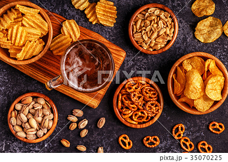 Beer with snacks on stone background. 35070225