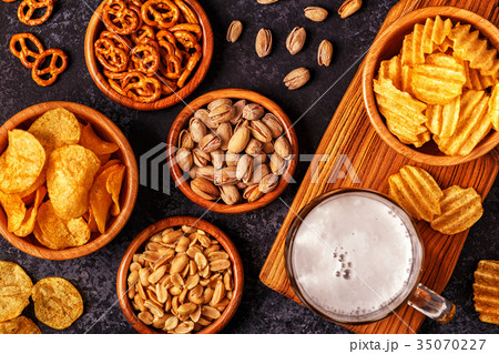 Beer with snacks on stone background. 35070227
