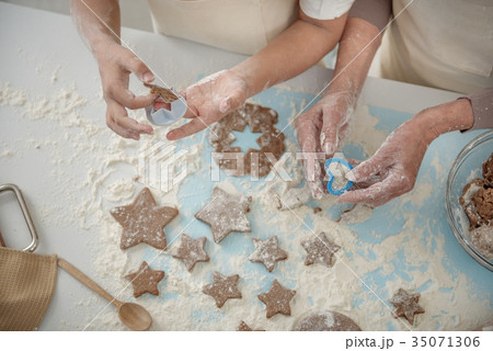 Skillful arms sculpting cookies before baking 35071306