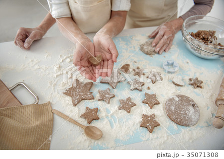 Girl presenting self-made shape of dough in hands Girl presenting self-made shape of dough in hands 35071308