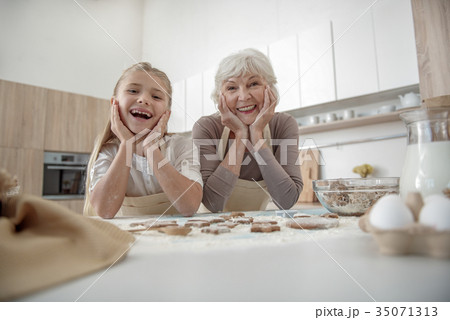 Happy girl likes to cook with her granny 35071313